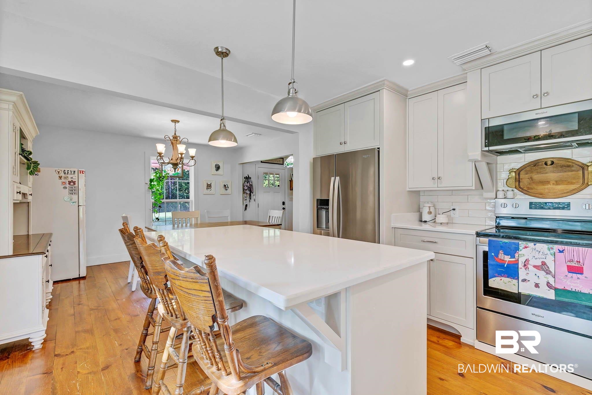 7564 Rabbit Run Road Fairhope, AL 36532 - Photo 25 of 88 Kitchen with stainless steel appliances, tasteful backsplash, a center island, a breakfast bar area, and a chandelier