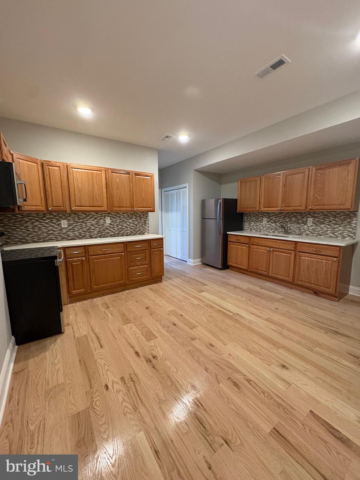 2900 North 5th Street, Unit 4 Philadelphia, PA 19133 - Photo 5 of 7 a kitchen with stainless steel appliances kitchen island granite countertop a refrigerator and a sink