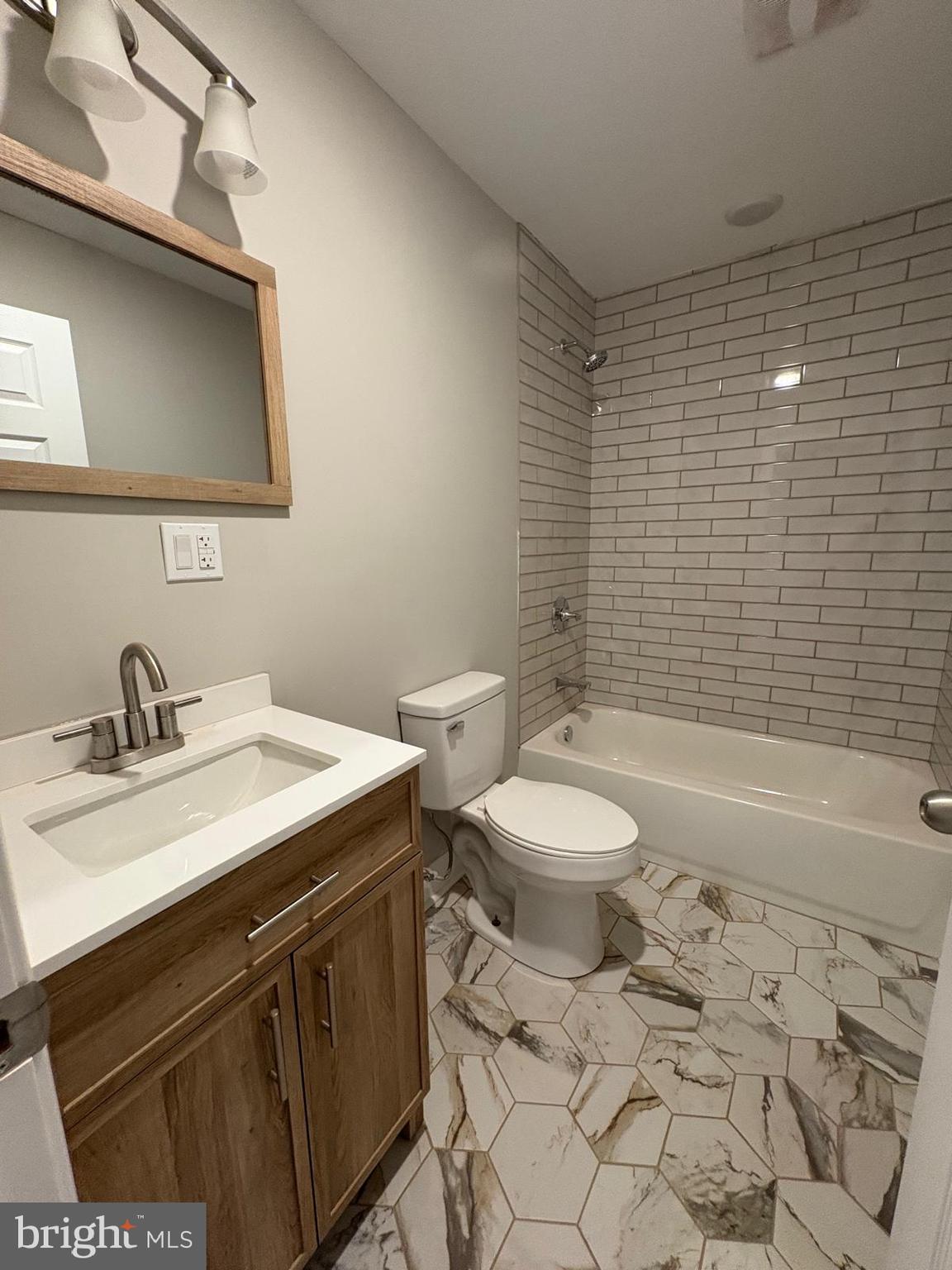 2900 North 5th Street, Unit 4 Philadelphia, PA 19133 - Photo 6 of 7 a bathroom with a sink toilet vanity and tub