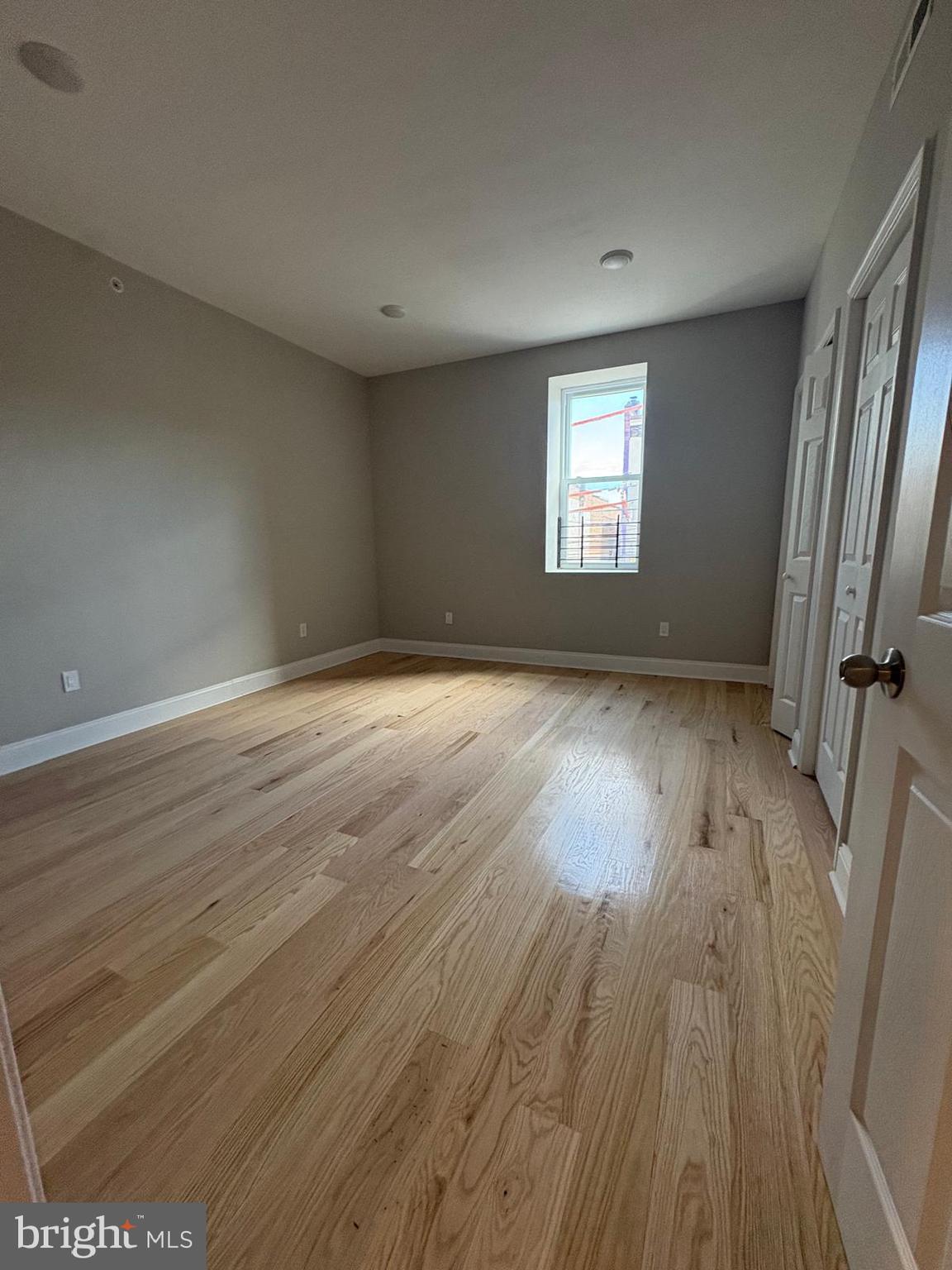 2900 North 5th Street, Unit 4 Philadelphia, PA 19133 - Photo 7 of 7 an empty room with wooden floor and windows
