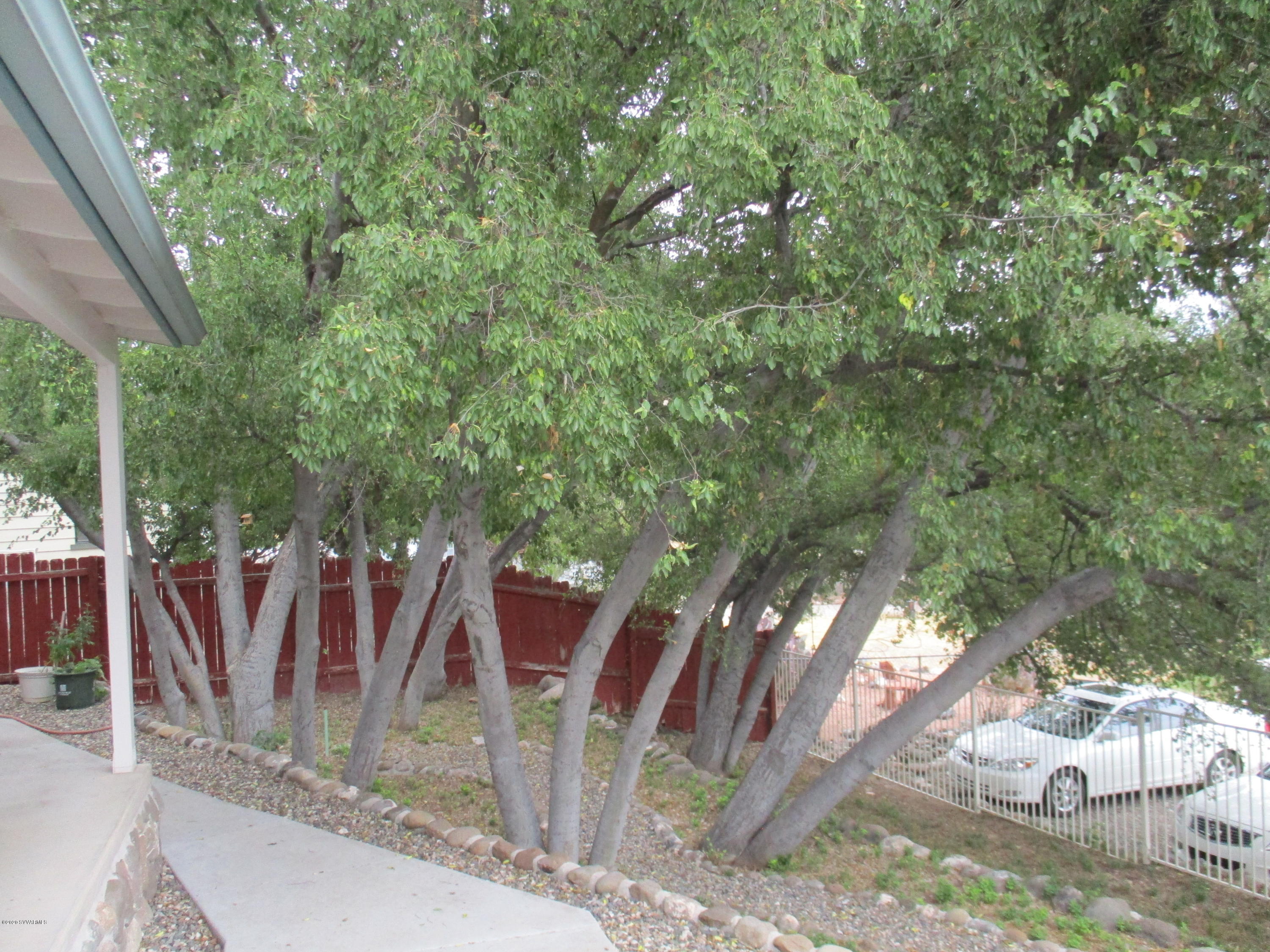 4190 East Aztec Road Rimrock, AZ 86335 - Photo 33 of 35 a view of a backyard with table and chairs and wooden fence