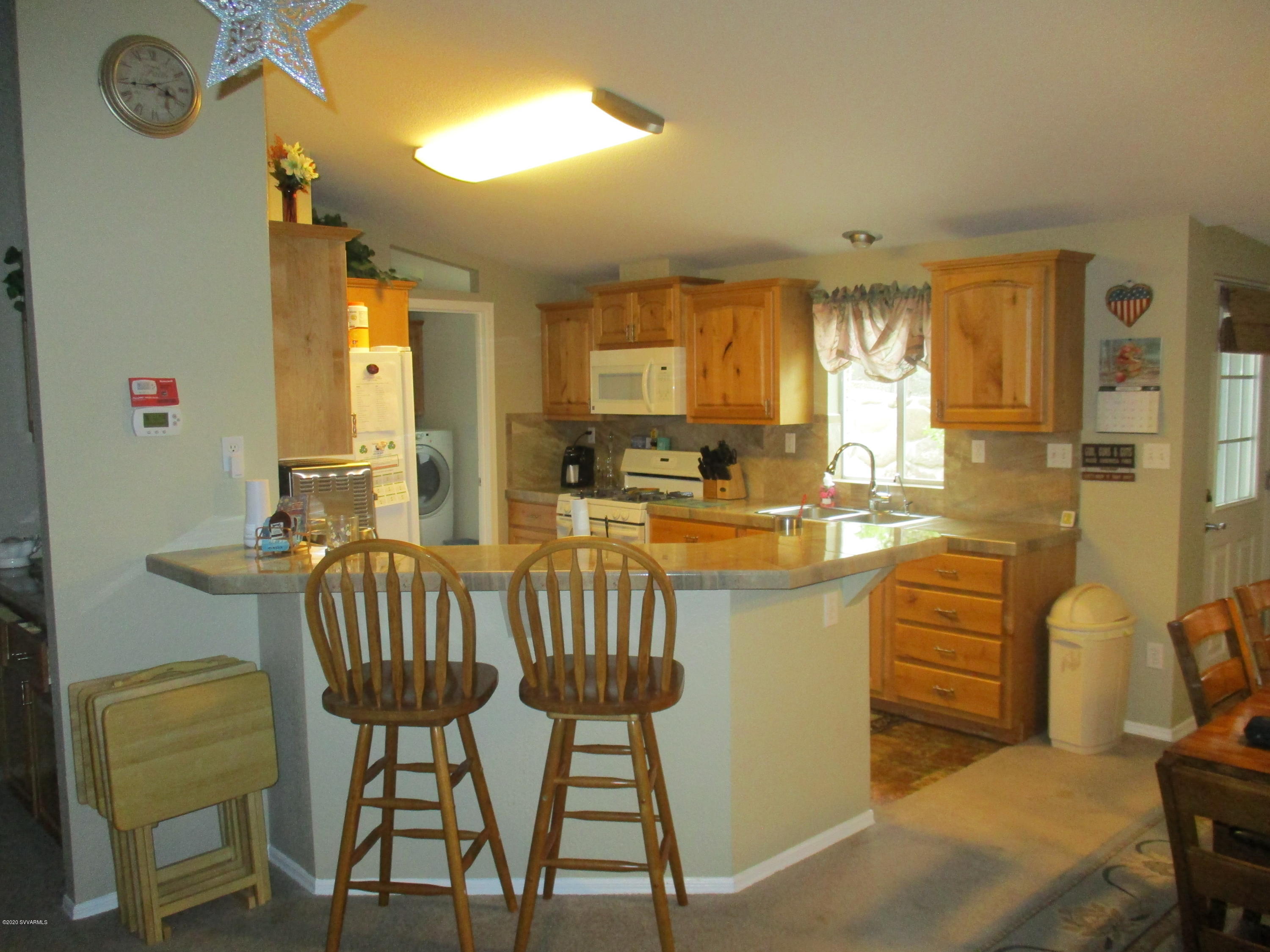 4190 East Aztec Road Rimrock, AZ 86335 - Photo 6 of 35 a kitchen with a table chairs stove and cabinets
