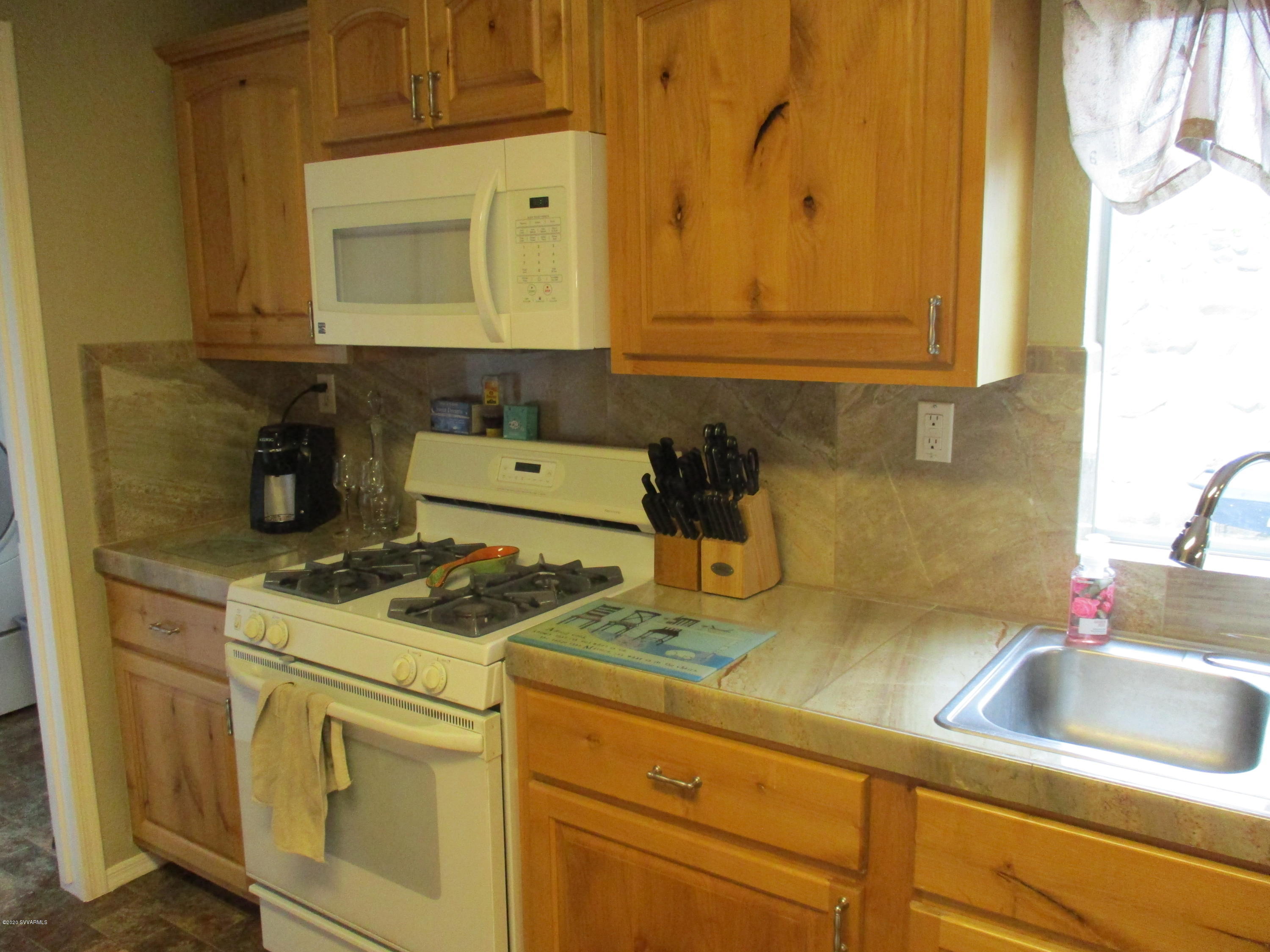 4190 East Aztec Road Rimrock, AZ 86335 - Photo 7 of 35 a kitchen with stainless steel appliances granite countertop a sink stove and cabinets