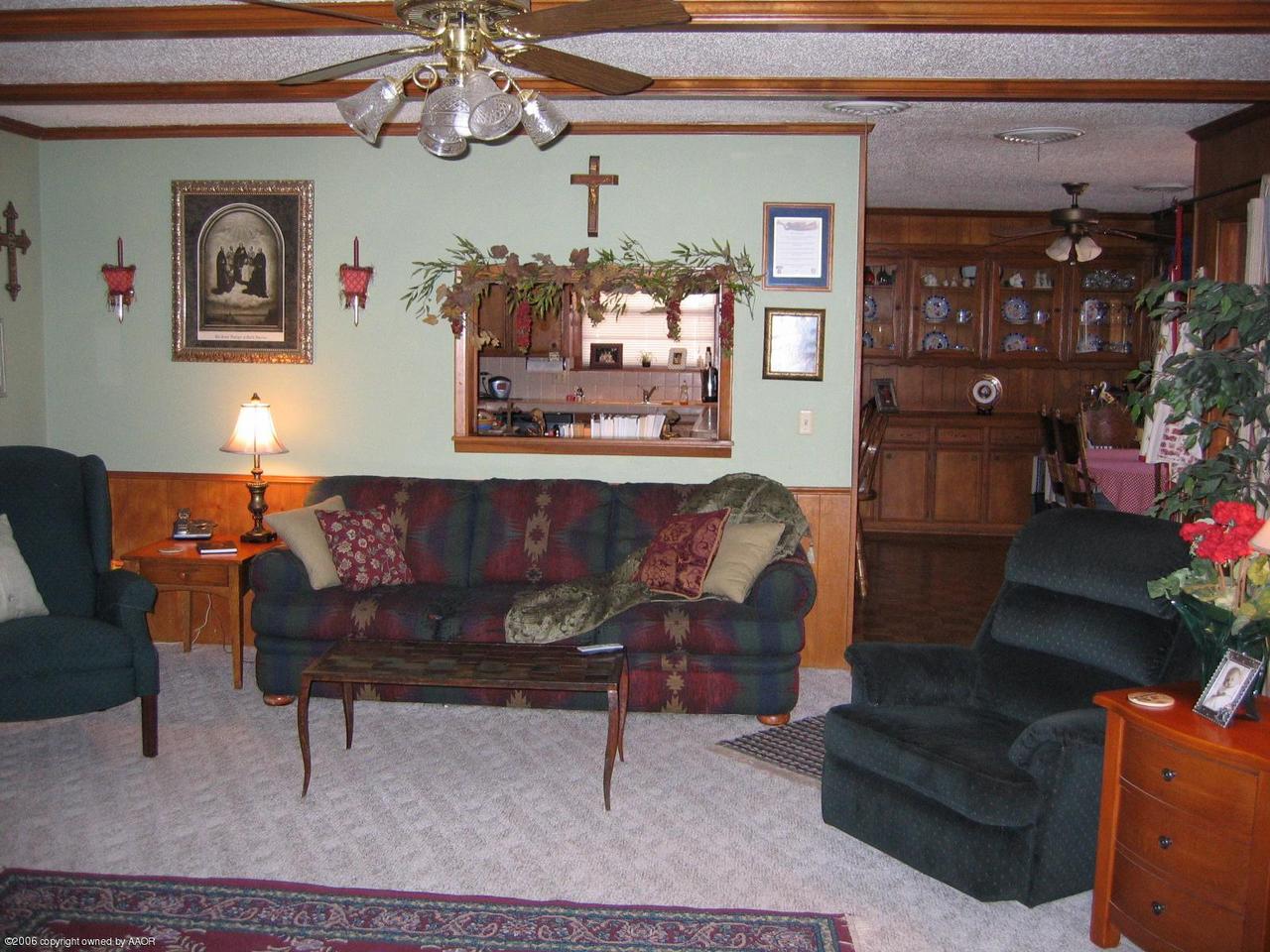 7212 Calumet Road Amarillo, TX 79106 - Photo 2 of 8 a living room with furniture and flowers
