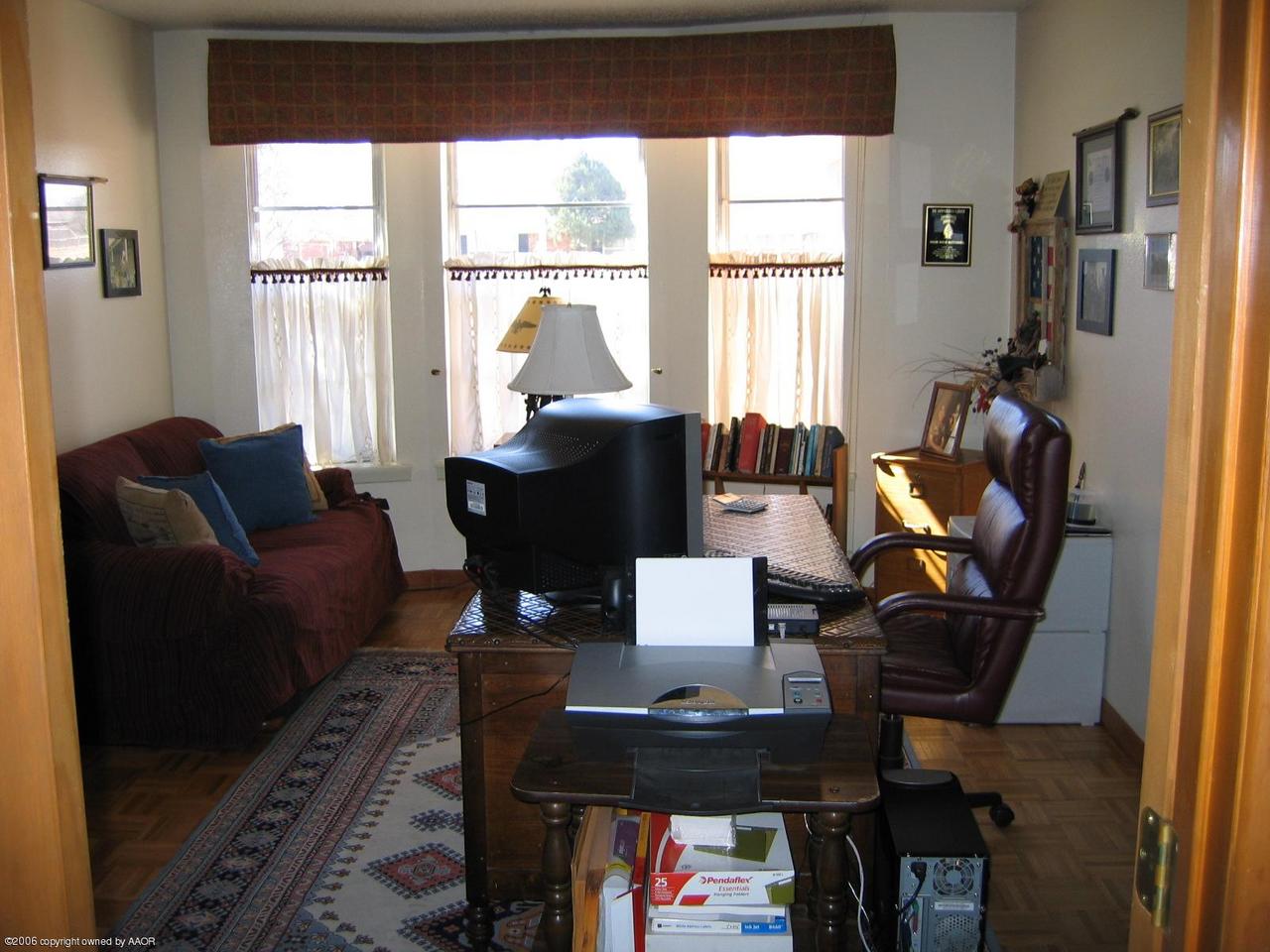 7212 Calumet Road Amarillo, TX 79106 - Photo 7 of 8 a living room with furniture and a window