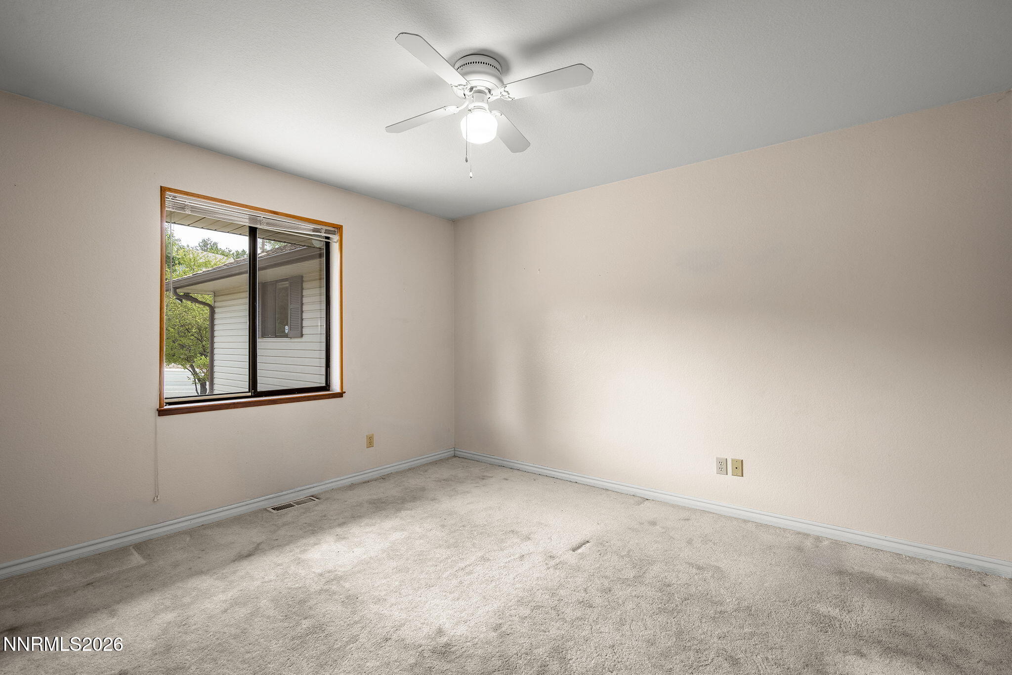 2985 Socrates Drive Reno, NV 89512 - Photo 39 of 52 an empty room with windows and fan