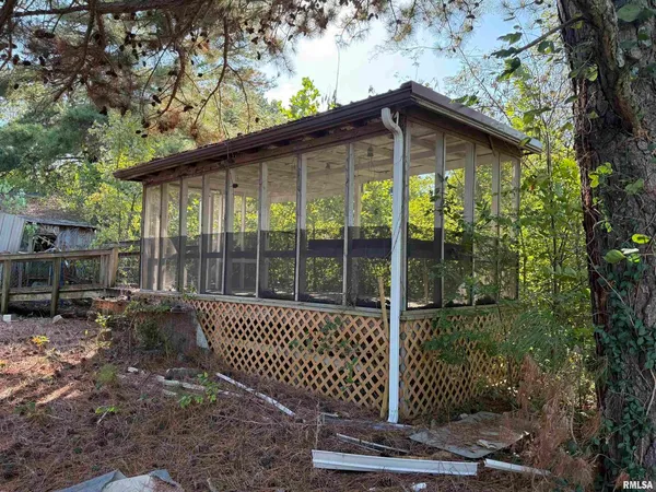 a backyard of a house with a large tree