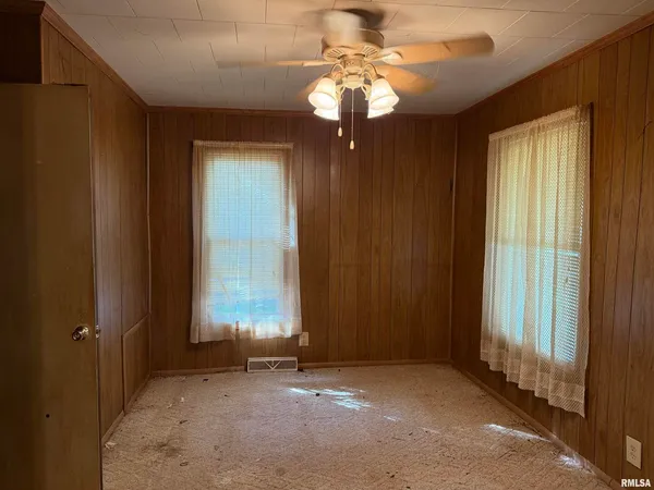 an empty room with windows closet and flowerpot