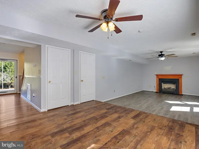 a view of a livingroom with a ceiling fan and window