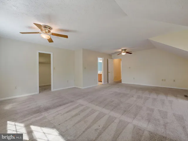 a view of a livingroom with a ceiling fan and window
