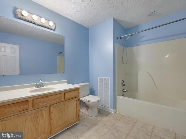 a bathroom with a double vanity sink mirror and toilet