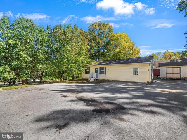a view of a house with a yard and garage