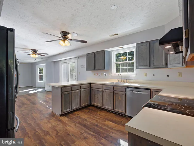 a kitchen with a stove a sink and a refrigerator
