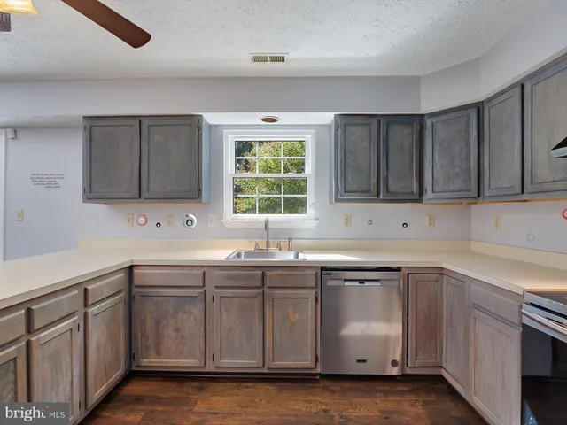 a kitchen with a sink stove and cabinets