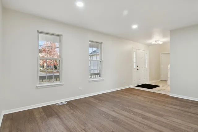 a view of entryway with furniture and wooden floor