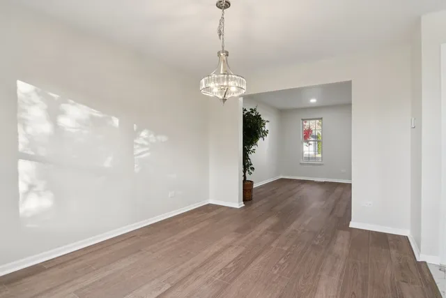 a view of a livingroom with wooden floor and a fireplace