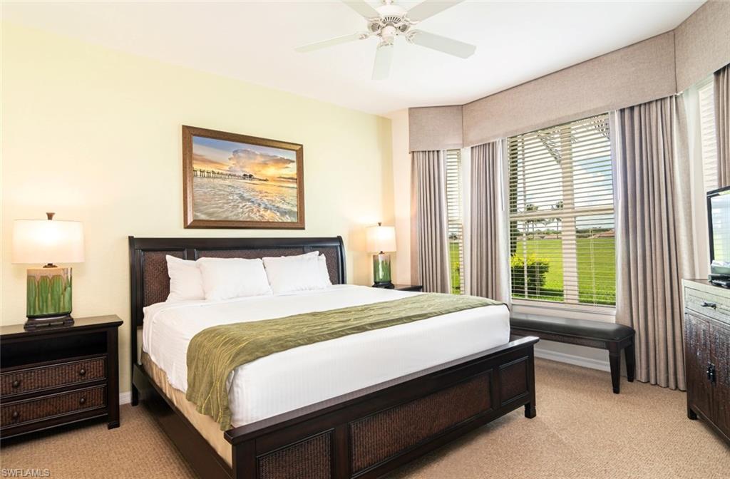 7955 Mahogany Run Lane, Unit 515 Naples, FL 34113 - Photo 2 of 20 a large bed sitting in a bedroom next to a window