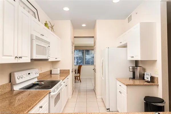 a kitchen with a sink a stove and cabinets