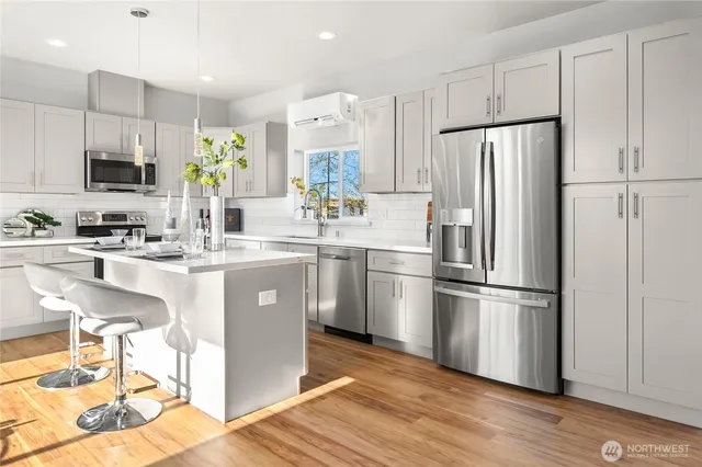 a kitchen with appliances a sink and a refrigerator