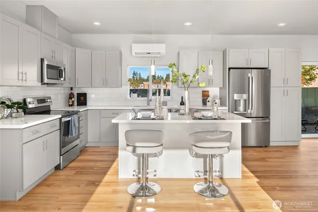 a kitchen with stainless steel appliances kitchen island granite countertop a sink and cabinets