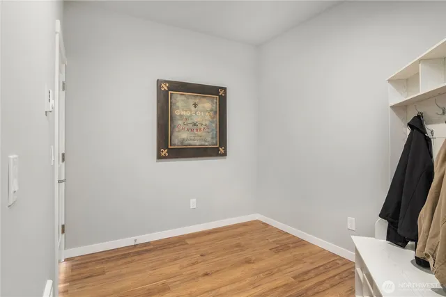 a view of a room with wooden floor and a ceiling fan