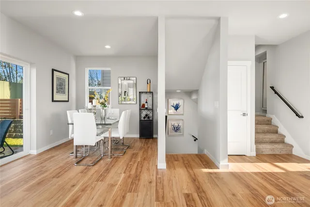 a view of a livingroom with wooden floor and furniture