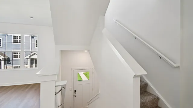 a kitchen with stainless steel appliances a stove a sink a refrigerator white cabinets and wooden floor