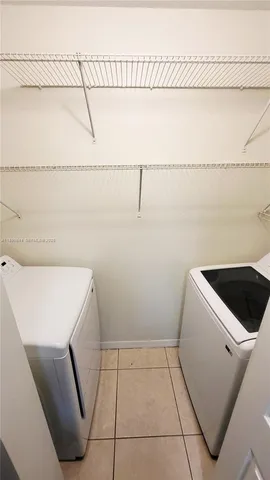 an empty room with wooden floor and mirror