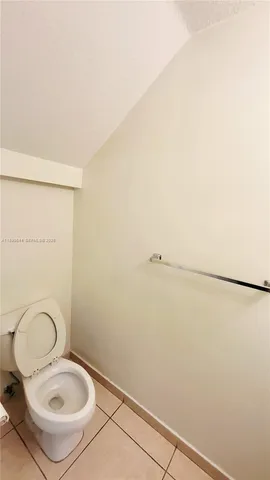 a view of a hallway with wooden floor and glass door