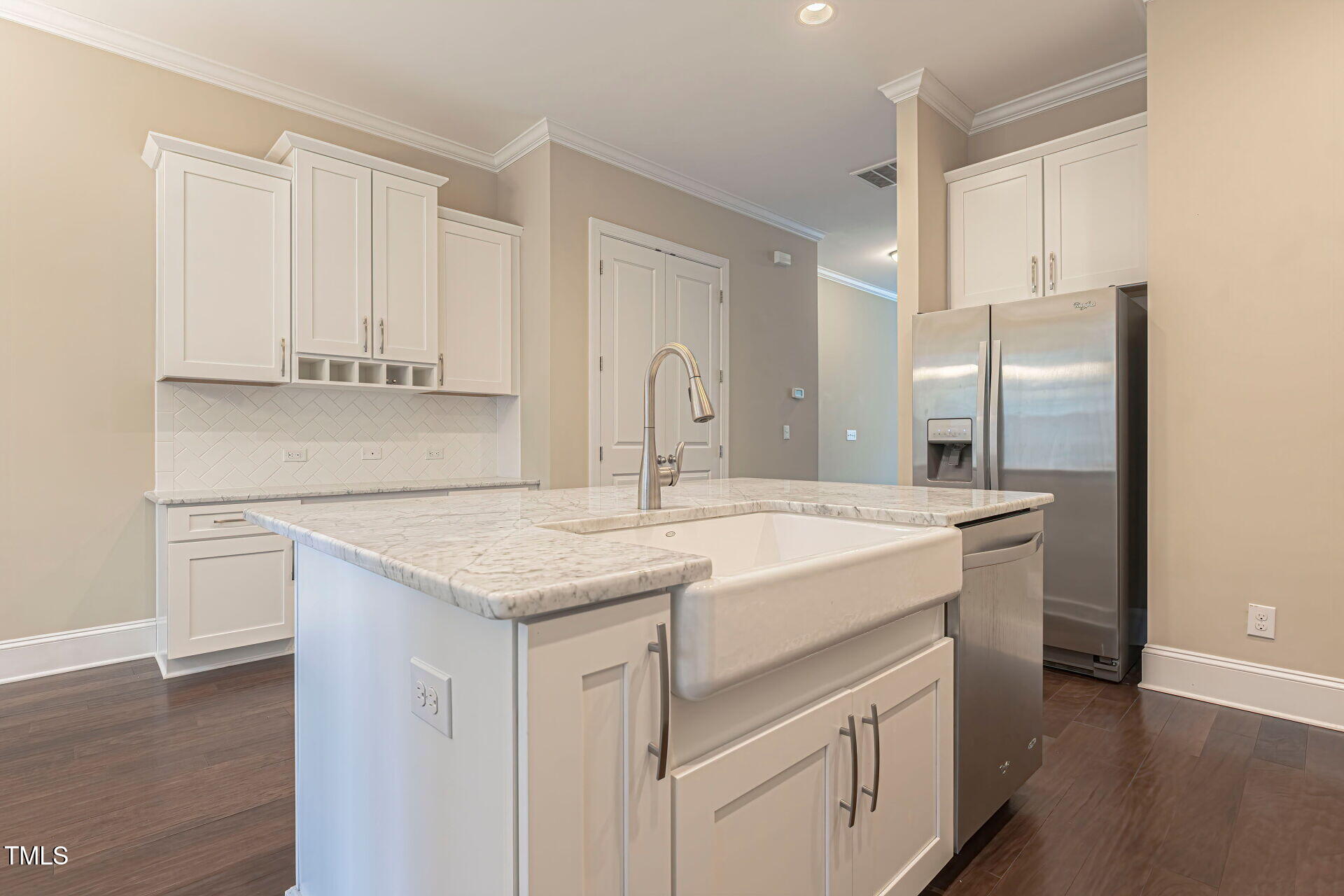 3606 Winifred Way Raleigh, NC 27609 - Photo 11 of 45 a kitchen with kitchen island granite countertop a sink and refrigerator