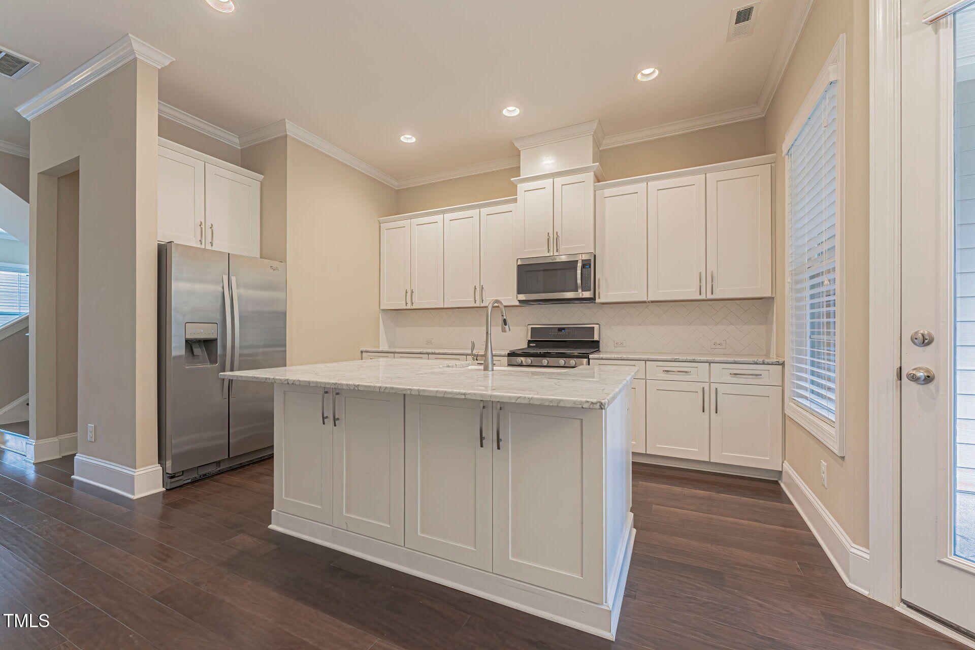3606 Winifred Way Raleigh, NC 27609 - Photo 12 of 45 a kitchen with kitchen island white cabinets and stainless steel appliances