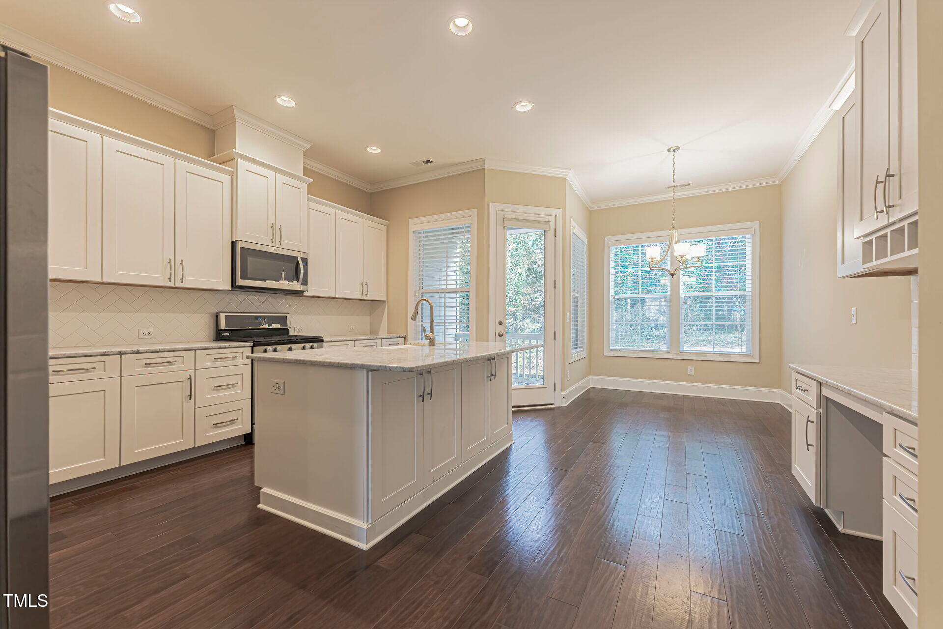 3606 Winifred Way Raleigh, NC 27609 - Photo 13 of 45 a kitchen with wooden floors and white appliances
