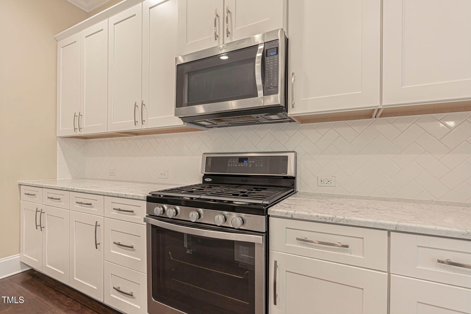 3606 Winifred Way Raleigh, NC 27609 - Photo 14 of 45 a kitchen with white cabinets and appliances