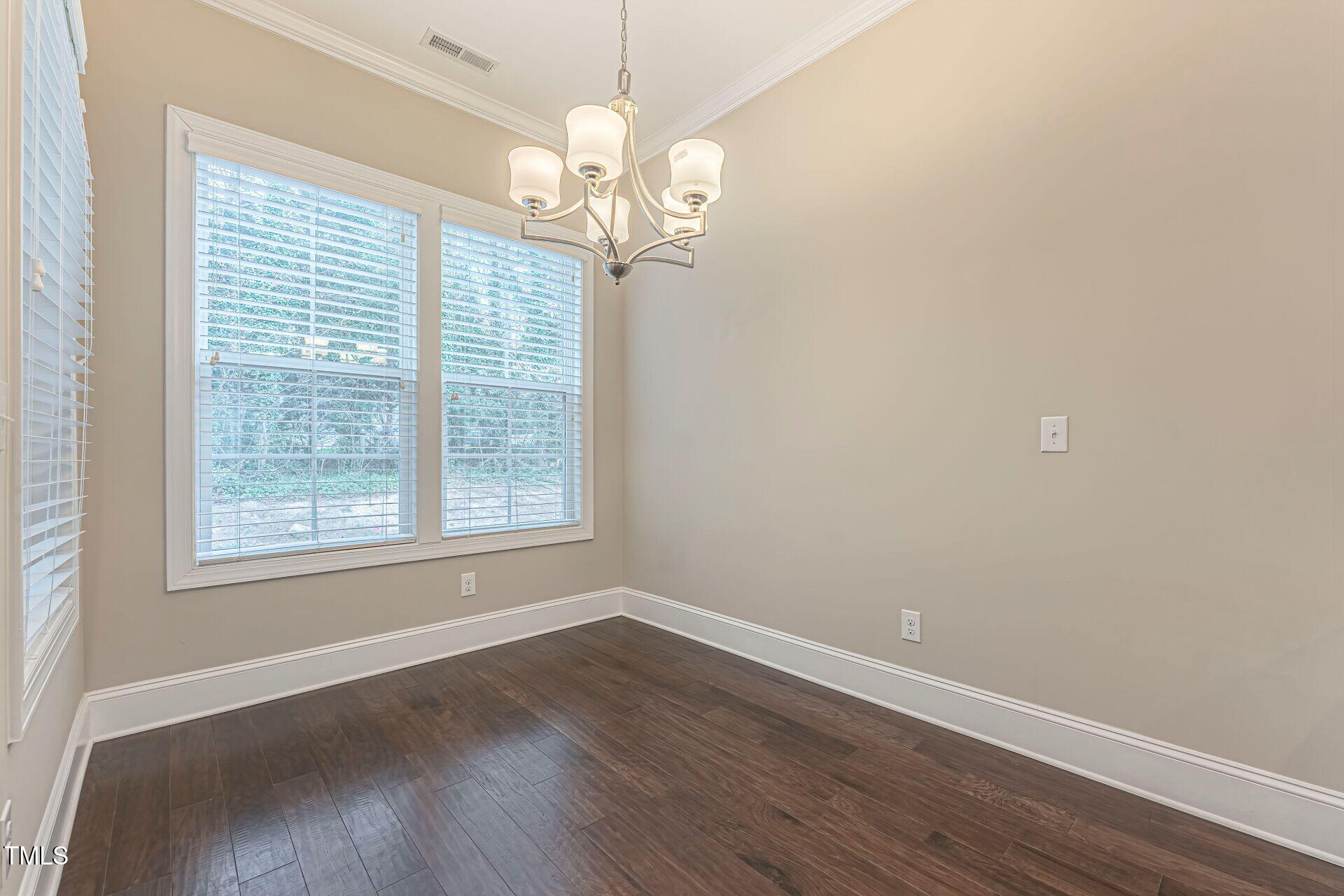 3606 Winifred Way Raleigh, NC 27609 - Photo 17 of 45 a view of an empty room with wooden floor and a window