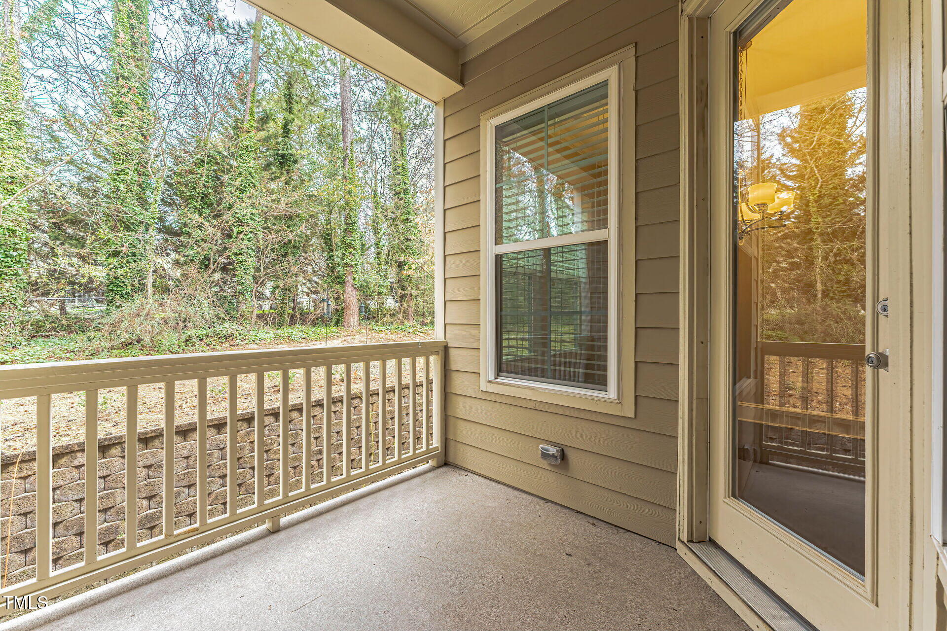 3606 Winifred Way Raleigh, NC 27609 - Photo 19 of 45 a view of a porch with a floor to ceiling window and an outdoor view