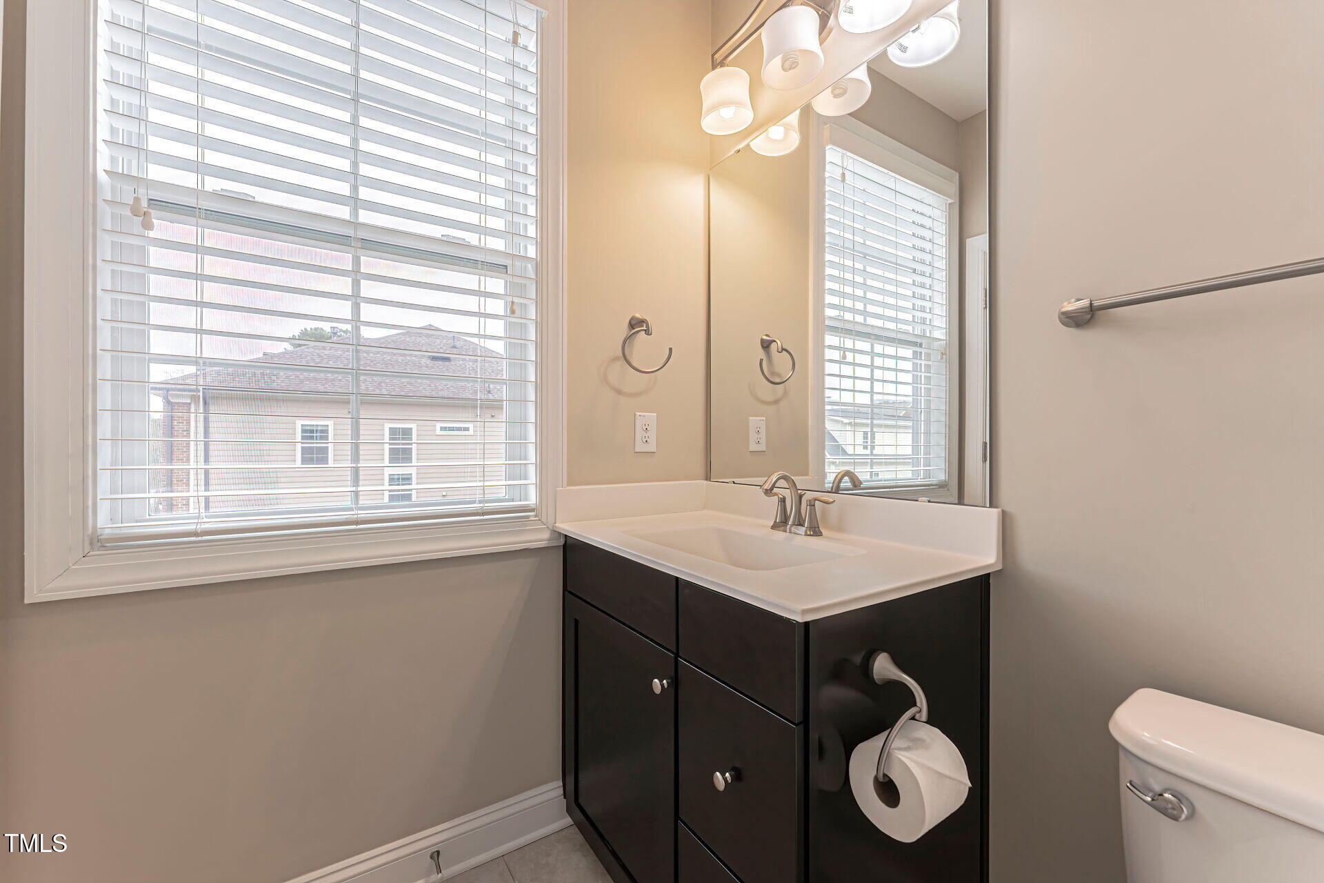 3606 Winifred Way Raleigh, NC 27609 - Photo 26 of 45 a bathroom with a sink vanity and a mirror