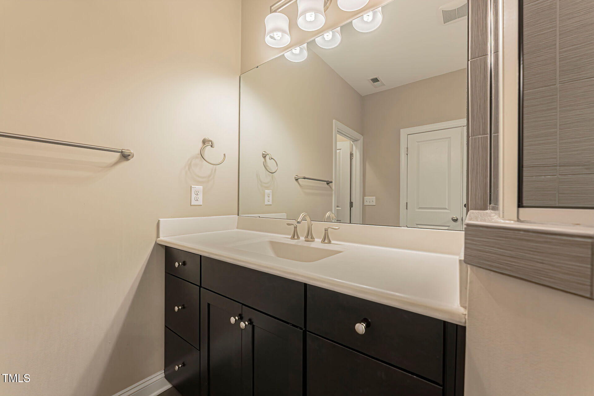 3606 Winifred Way Raleigh, NC 27609 - Photo 32 of 45 a bathroom with a sink a vanity and a mirror