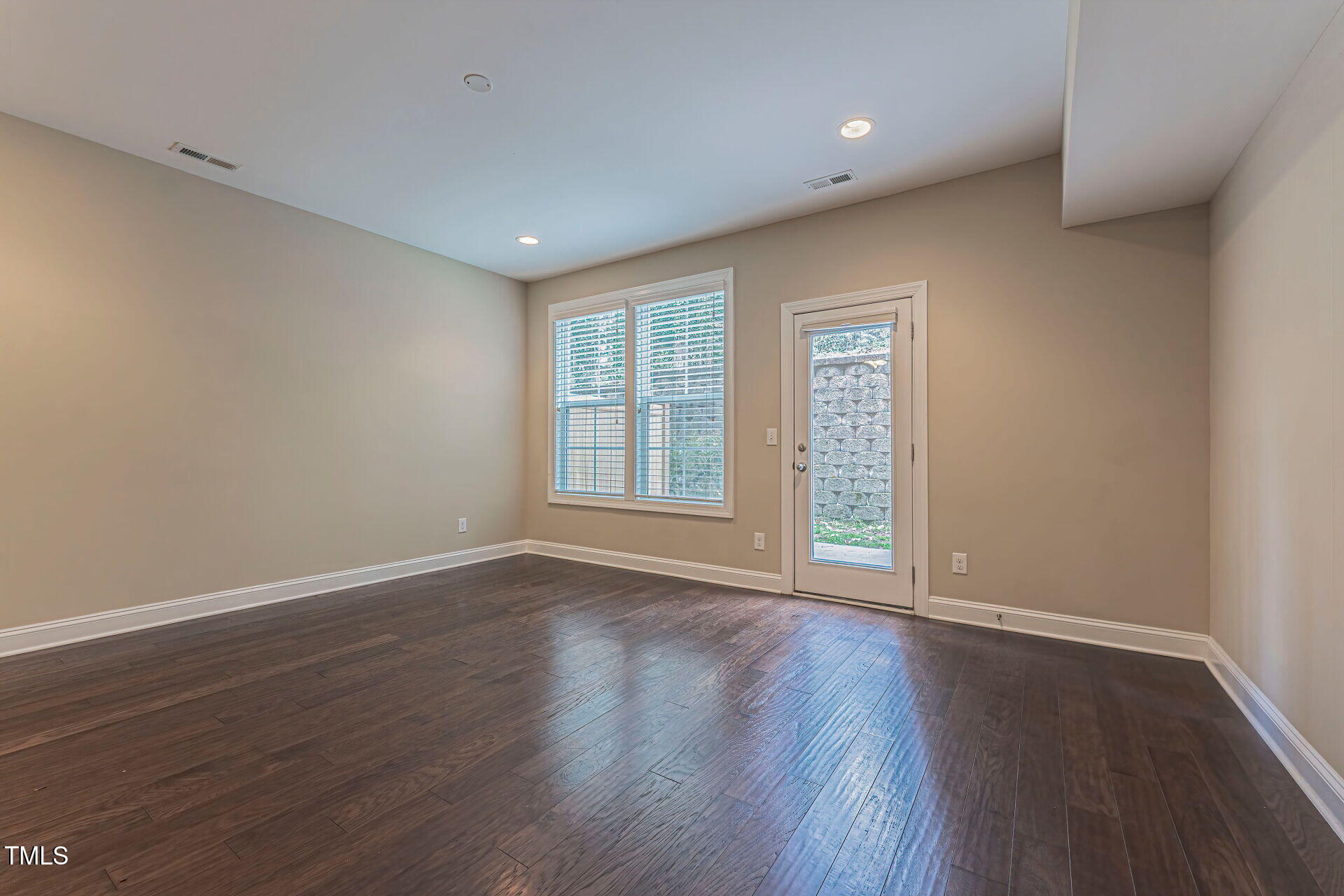 3606 Winifred Way Raleigh, NC 27609 - Photo 37 of 45 a view of an empty room with wooden floor and a window