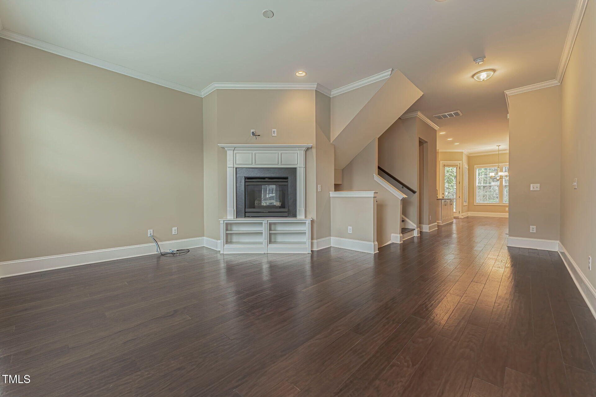3606 Winifred Way Raleigh, NC 27609 - Photo 5 of 45 a view of an empty room with wooden floor and a fireplace