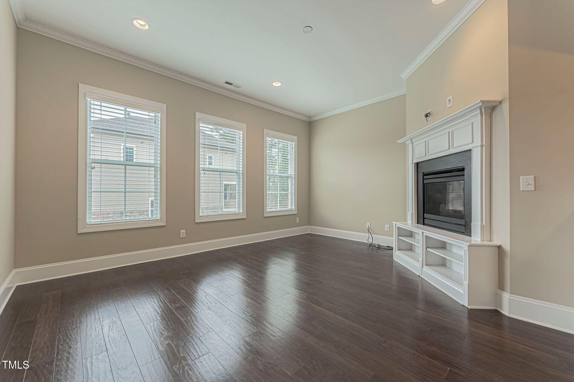 3606 Winifred Way Raleigh, NC 27609 - Photo 6 of 45 a view of an empty room with wooden floor and a window
