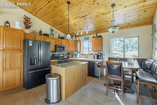 a kitchen with a refrigerator and a table