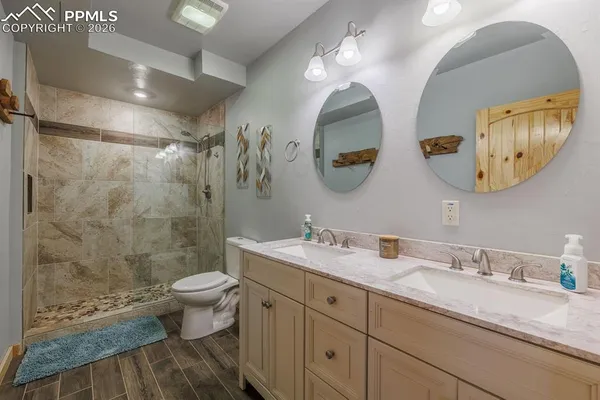 a bathroom with a granite countertop sink mirror and toilet