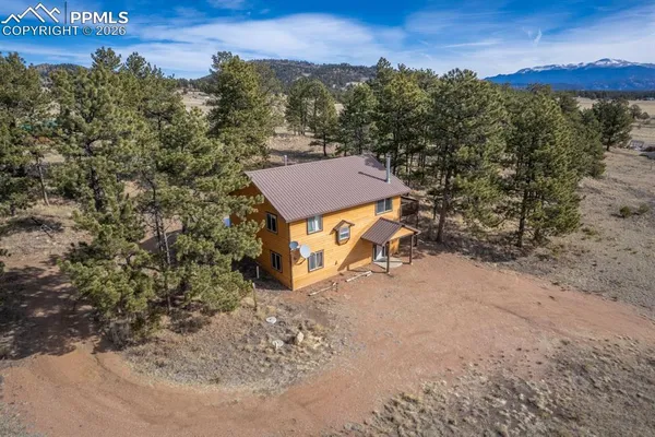 an aerial view of a house with a yard