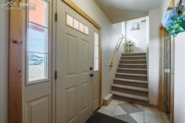 a view of entryway with furniture and stairs