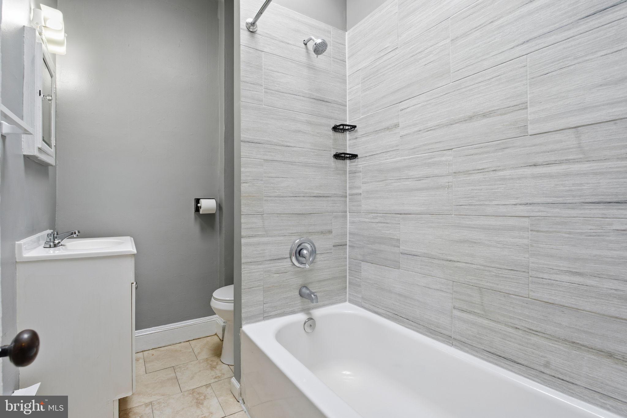5 South Wickham Road, Unit 2 Baltimore, MD 21229 - Photo 11 of 15 a bathroom with a tub and a shower