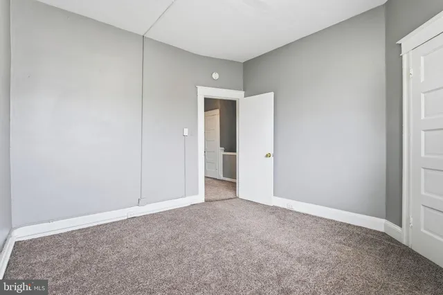 a view of an empty room and closet area