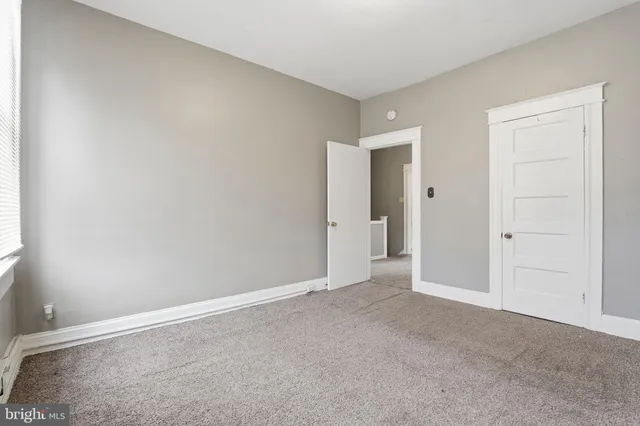 a view of an empty room and closet area