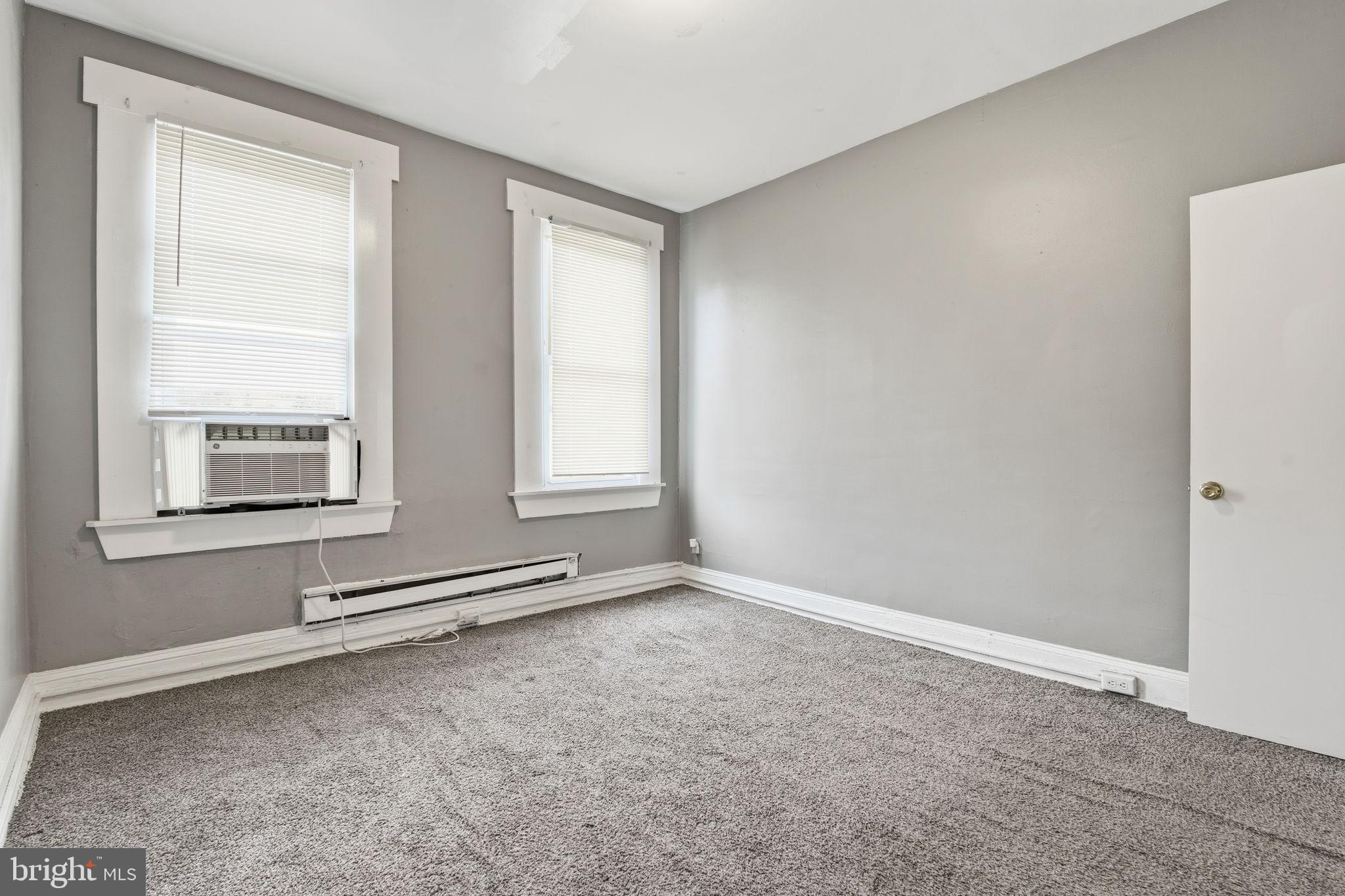 5 South Wickham Road, Unit 2 Baltimore, MD 21229 - Photo 7 of 15 an empty room with windows