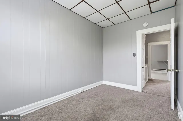 a picture of a bench in front of a wall