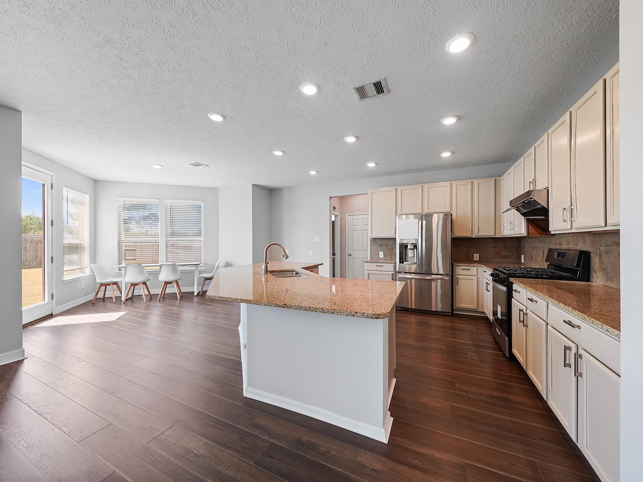 24131 Adobe Ridge Lane Katy, TX 77493 - Photo 12 of 37 a large kitchen with stainless steel appliances granite countertop a large center island and a sink